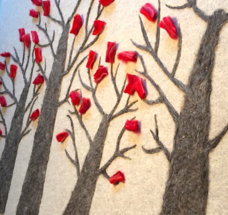 Red flowers on bare branches in felted wool
